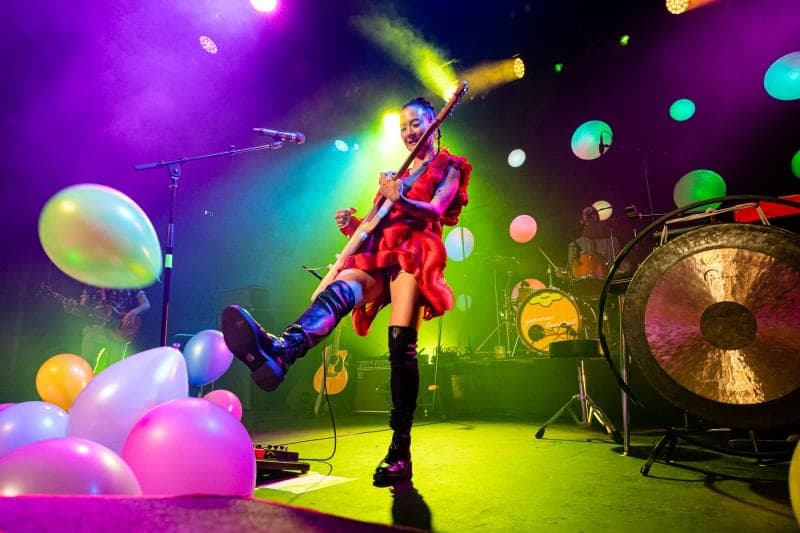 Japanese Breakfast on stage with LED persimmons