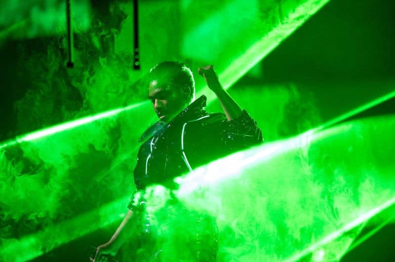 Childish Gambino on stage in a light-up jacket on The New World Tour
